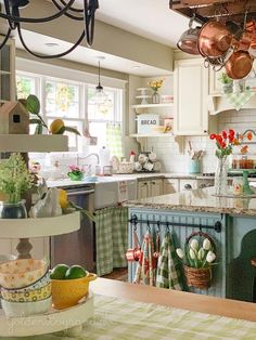 a kitchen filled with lots of pots and pans on top of a counter next to a sink