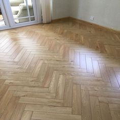 an empty room with wooden floors and sliding glass doors