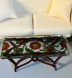 a glass table sitting on top of a white couch