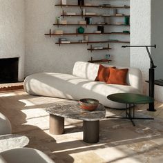 a living room filled with furniture and a fire place in the middle of it's wall