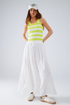 Add a touch of elegance to your wardrobe with our Maxi Skirt in White Fluid Fabric with Elastic Waist. Crafted from 100% viscose, this skirt offers a lightweight and breathable feel, making it perfect for warm weather. The skirt features a flowy A-line silhouette that falls gracefully to a maxi length, creating a beautiful and relaxed fit. The elastic waist ensures comfort and ease of wear, making it an ideal choice for daily wear. The versatile white color allows for easy pairing with various t