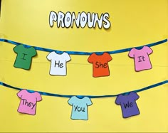 a bulletin board with clothes hanging from it's sides and the words pronouns written on them