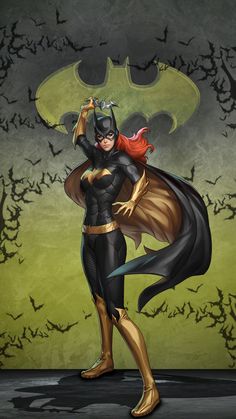 a woman dressed as batgirl standing in front of bats