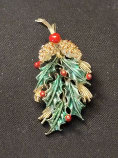 "1970s Signed Gerry's Gold Finish Holly Berries Pinecones Brooch Red Green Enamel Gerrys.  This pretty piece measures 1\" wide by just over 2\" long.   Minor loss of enamel, which is common with these well loved and worn brooches." Holly Berries, Green Enamel, Pine Cones, Gold Finish, Red Green, Brooches, 1970s, Signs, Green