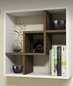 a shelf with some books and vases on it