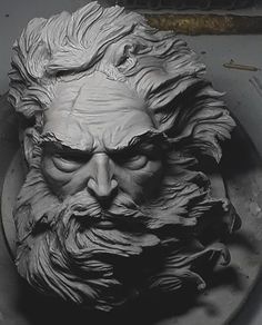 a clay sculpture of an old man's face