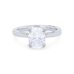 a white gold ring with a oval cut diamond in the center