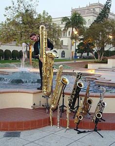 a man standing next to a fountain with musical instruments