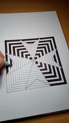 a person is using a pen to draw a design