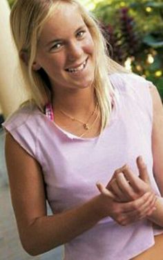 a woman in pink shirt and shorts posing for the camera with her hand on her hip