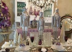 the table is set with silver and white dishes