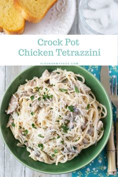 a green bowl filled with chicken tetrazzini on top of a white table