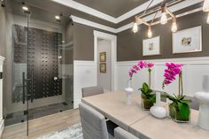 a bathroom with a walk in shower and two vases on the counter next to it