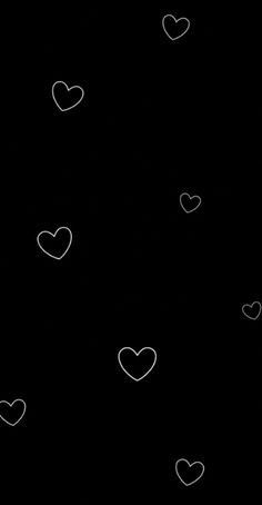 a black background with hearts drawn on it