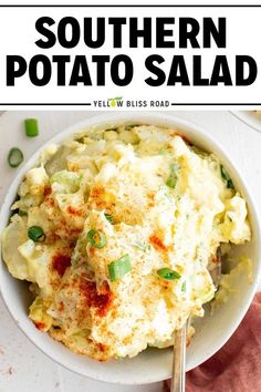 a white bowl filled with potato salad on top of a table