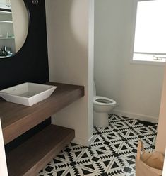 a bathroom with black and white tile flooring