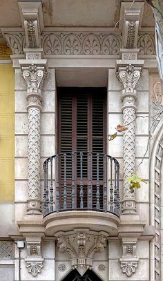 an old building with a balcony and wrought iron balconies on the front door