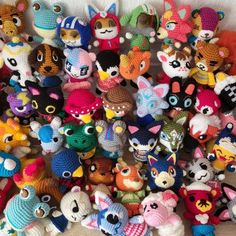 a pile of crocheted stuffed animals sitting on top of a wooden floor next to each other