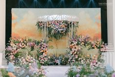 the stage is decorated with flowers and greenery