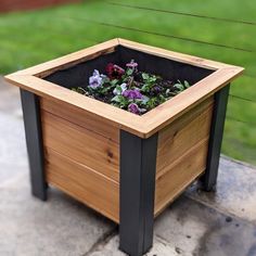 a wooden planter with plants growing in it