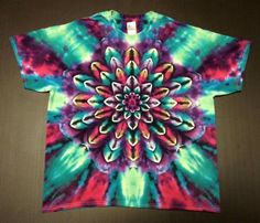 a colorful tie - dyed t - shirt with an intricate flower design