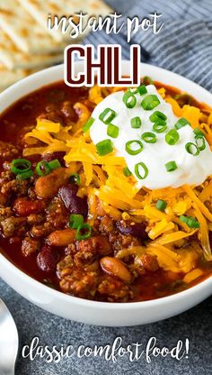 a white bowl filled with chili and cheese