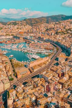 an aerial view of the city and harbor in barcelona, spain with boats on the water