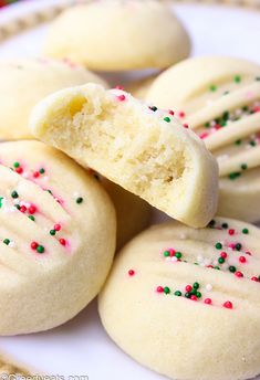 some cookies with sprinkles are on a plate