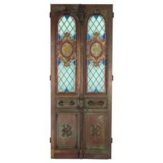 an ornate wooden door with stained glass panels