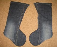 two pairs of blue jeans with holes in them on the floor next to each other