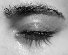 black and white photograph of an eye with long lashes