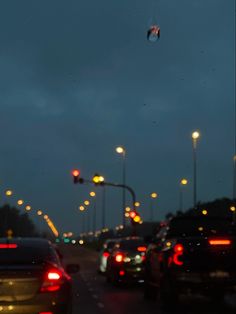 cars stopped at a red light in the evening