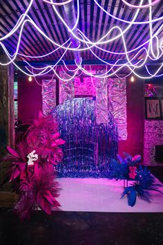 a stage set up with purple lights and decorations