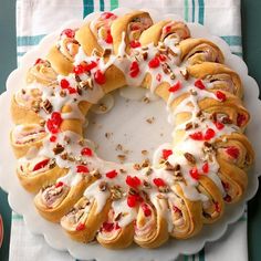 a white plate topped with a bundt cake covered in icing and toppings