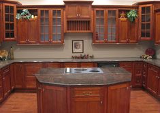 a kitchen with wooden cabinets and granite counter tops