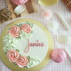 a cake that is sitting on top of a table with pink and white icing