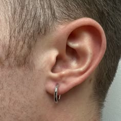 a close up of a man's ear with a ring on the middle of it