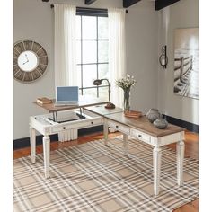 a living room filled with furniture next to a window and a rug on top of a hard wood floor