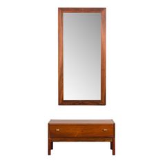 a mirror sitting on top of a wooden table next to a dresser with drawers underneath it