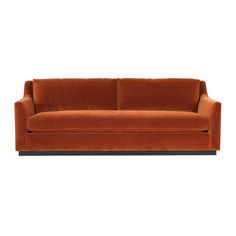 an orange couch sitting on top of a white floor