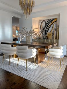 a dining room table with chairs and a chandelier