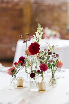 Fluffy and Bright dahlia. 6 bud vases in the center of the table, surrounded with tea light candles. each bud vase has a different mix of flowers. whisps of greens and staple flowers are circulated throughout. Modern Wedding Bud Vases, Farmhouse Table Bud Vases Wedding, Test Tube Vase Wedding, Neutral Wedding Flowers Bud Vases, Farm Table Wedding Decor Bud Vases, Industrial Wedding Flowers, Summer Garden Wedding, Wedding Table Flowers, Wedding Flower Decorations