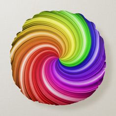 a multicolored circular object on a white background wall hanging in the shape of a spiral