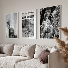 three black and white posters hang on the wall above a couch