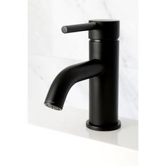 a black faucet sitting on top of a white counter