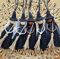 four wooden dolls with black hats and tassels on a woven place mat,