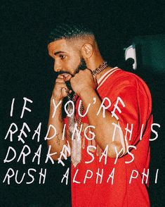 a man wearing a red shirt and writing on the wall with words written in white