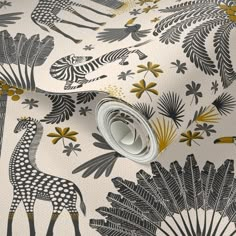 a giraffe and zebra wallpaper in gold, black, and white colors