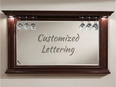 a mirror with wine glasses hanging from it's sides that says, customized lettering