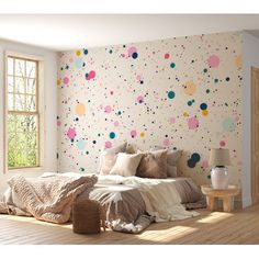 a bed sitting in a bedroom next to a window with polka dot wallpaper on it